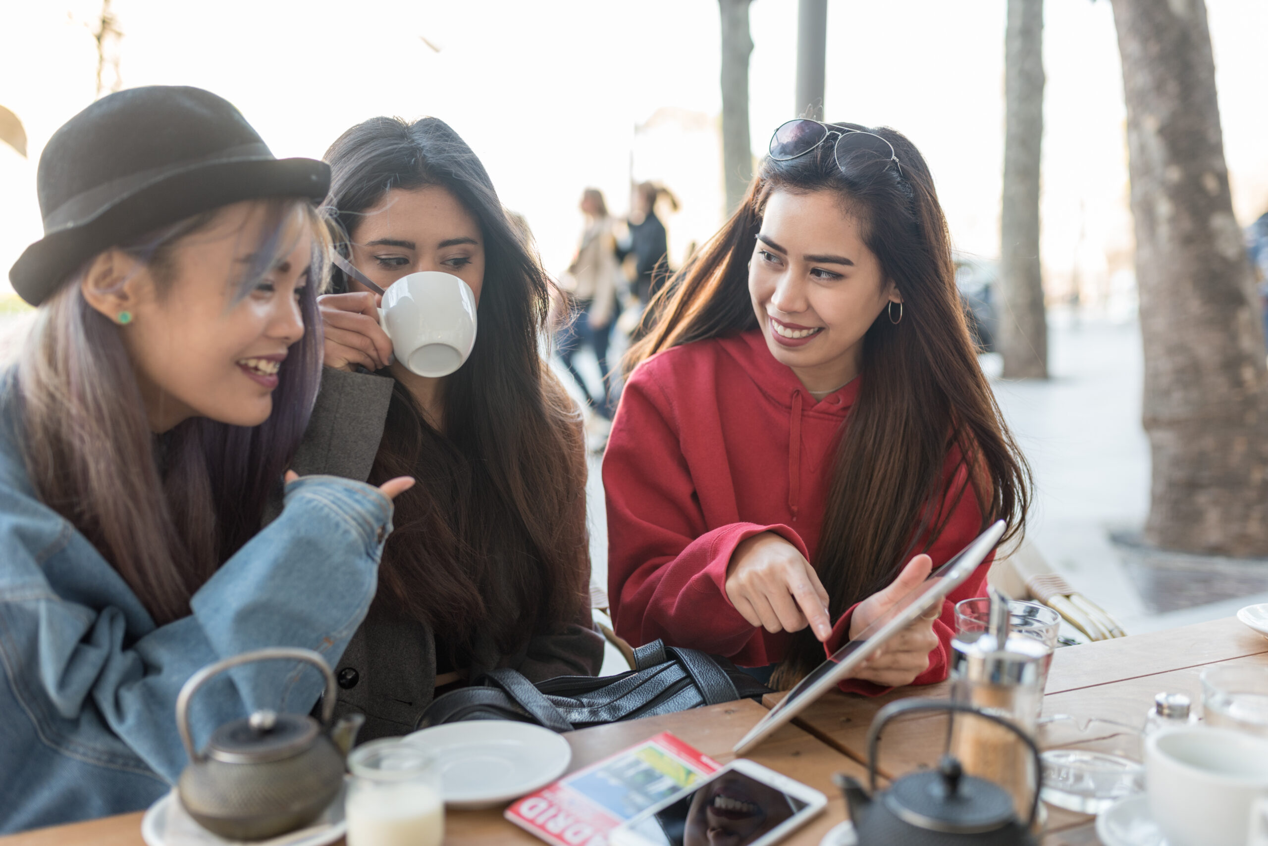 philippine friends women in a terrace in Madrid with tablet