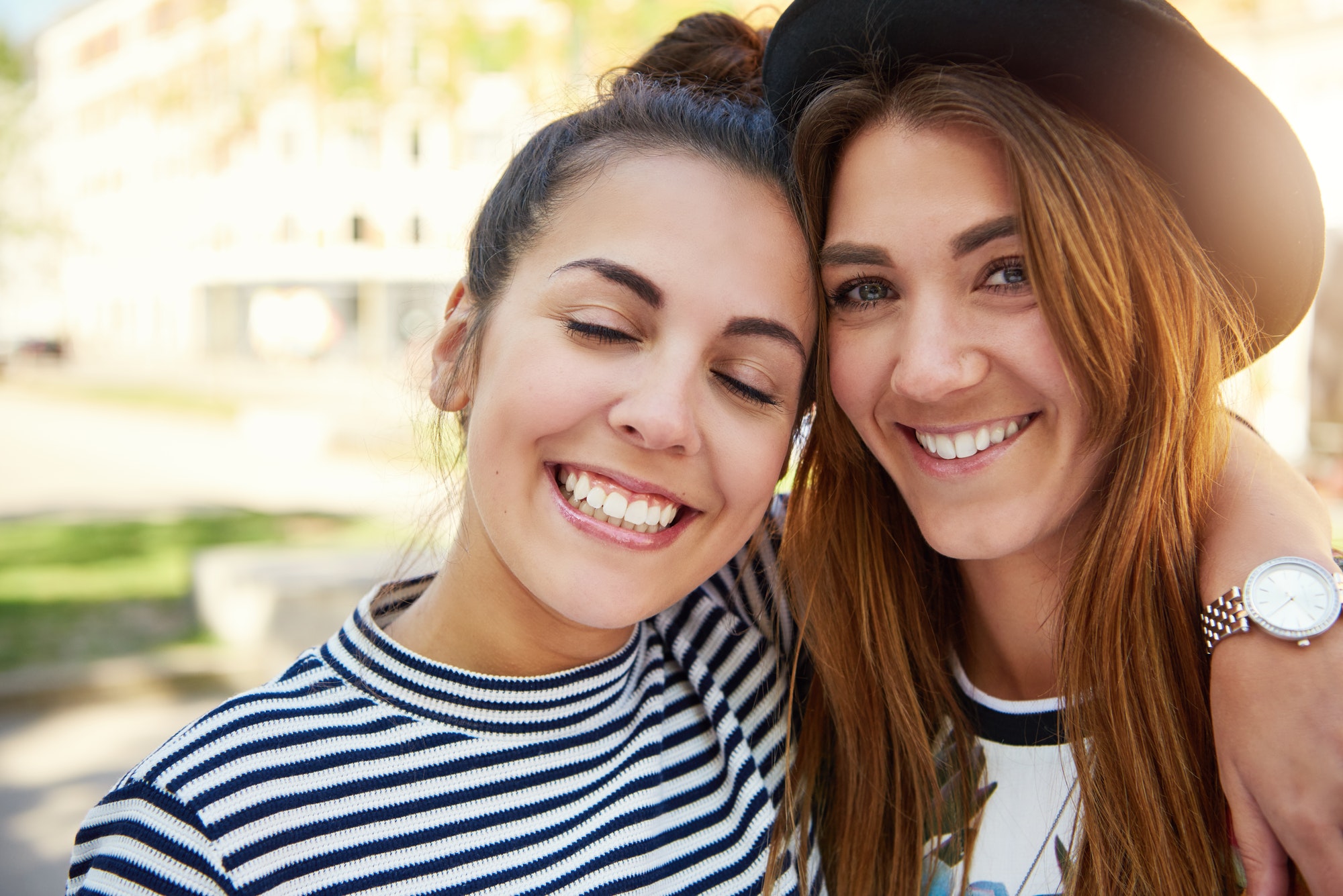 Two cute smiling young girl friends